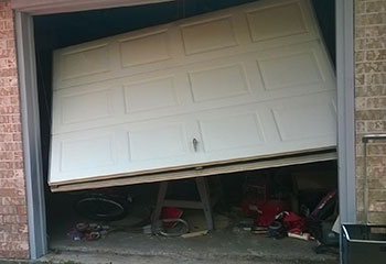 Close-up of damaged garage door panel and misaligned position in Cypress, CA