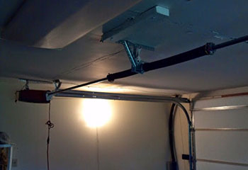 Professional installation of new extension spring on residential garage door in Cypress