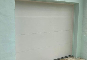 Brand new garage door with smooth painted finish after installation in Cypress, California