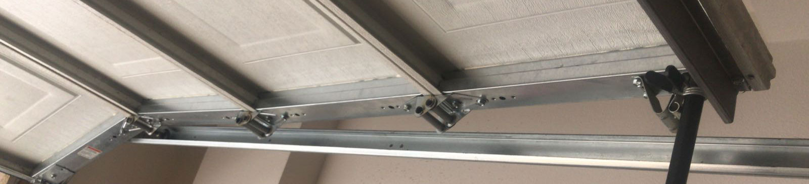 Old garage door awaiting replacement for Garden Grove, CA residence